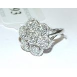 An 18ct white gold and diamond flowerhea