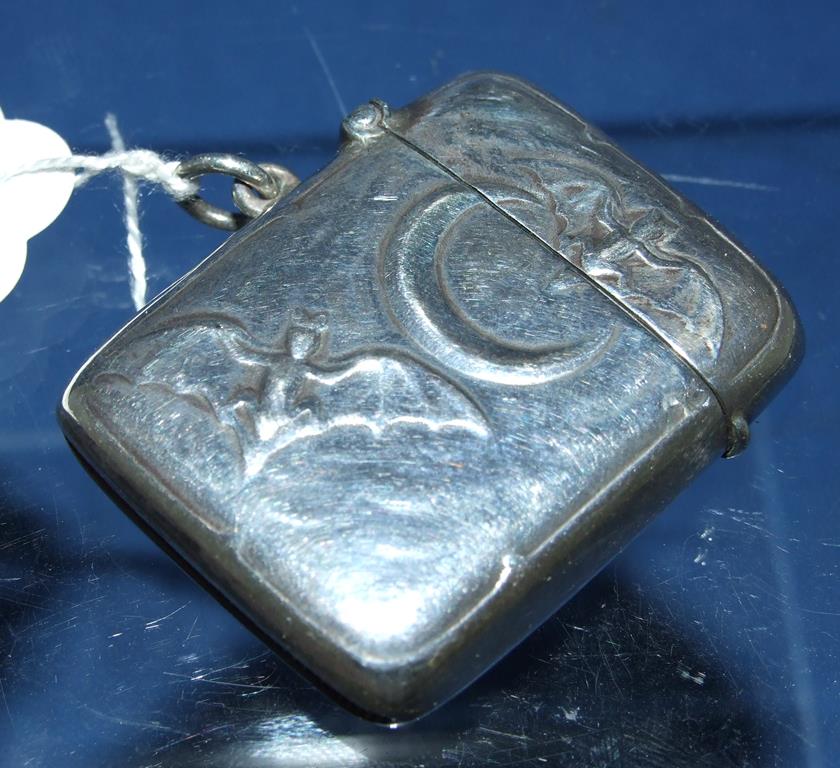 A silver bat and moon vesta case