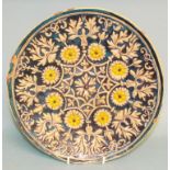 A Middle Eastern pottery plate, with flo