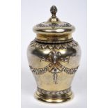 A Continental silver gilt tea caddy and cover, decorated rams head masks, swags,