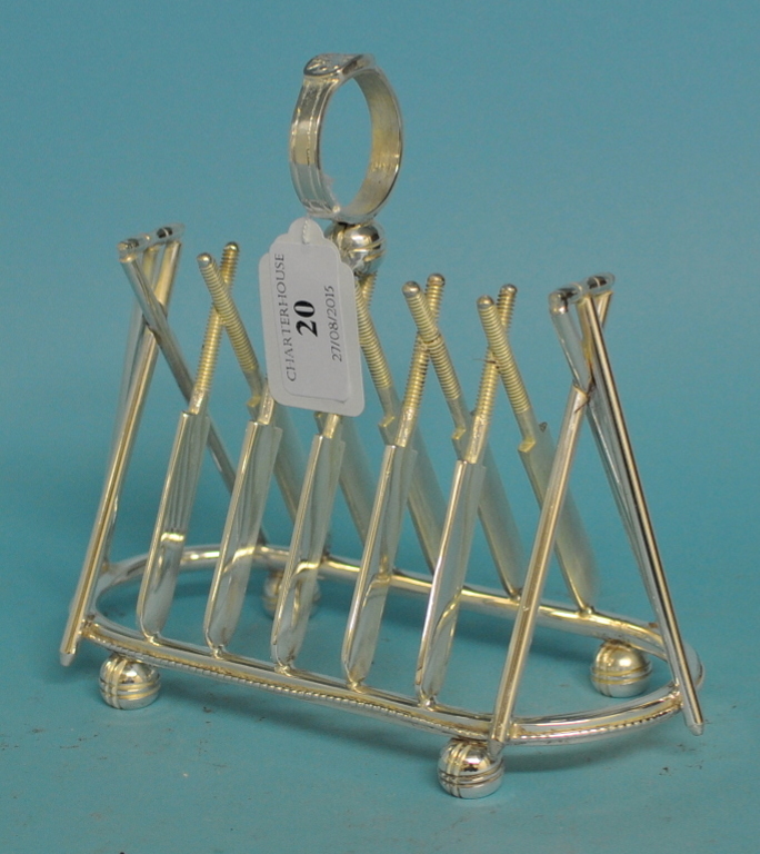 A plated toast rack, in the form of cricket bats, 16.