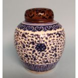 A Chinese porcelain ginger jar, decorated in underglaze blue, 17 cm high, with pierced hardwood