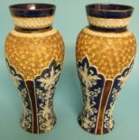 A pair of Doulton Lambeth stoneware vases, decorated stylised foliage, 28 cm high,