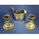 A pair of Victorian silver dwarf candlesticks, London 1890, 9 cm high, and a silver jug, approx. 3.