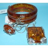 A silver and amber style bangle,