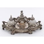 A Victorian silver plated ink stand, the central well with four elephant masks, flanked by a pair of