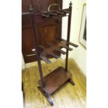 A mahogany whip, stock and boot rack with brass carrying handle,