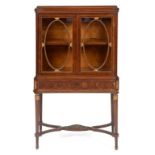 An inlaid mahogany display cabinet on stand, on tapering fluted legs joined by a shaped X stretcher,