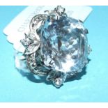 A white coloured metal clip, set a large aquamarine,