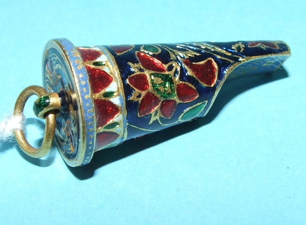 An Indian yellow coloured metal and enamel whistle, decorated birds, flowers and foliage Condition
