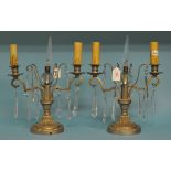 A pair of Continental silvered metal and glass candelabra, with prismatic drops,