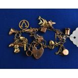 A 9ct gold charm bracelet, with assorted charms, 24.3 g (all in) Condition report Report by NG