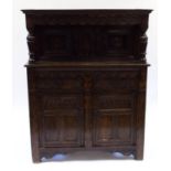 A 17th century style oak court cupboard, with carved decoration,