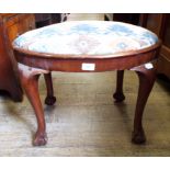 An oval upholstered stool,