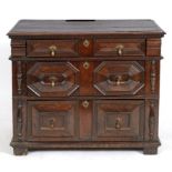 An early 18th century style oak chest, of three drawers, with geometric moulded fronts,