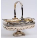 A Continental silver coloured metal swing handle basket, decorated a band of flowers and foliage,