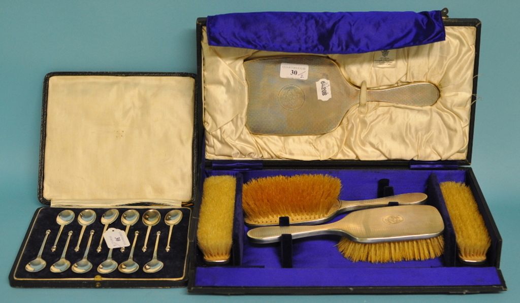 A set of twelve silver teaspoons, London 1920, and a silver dressing table set,