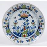 A Delft charger, decorated stylised flowers and foliage, in polychrome colours, 33.5 cm diameter