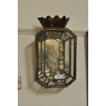 An octagonal single light wall lantern, fitted silvered mirror panels and brass finials,