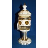 A Bohemian white and amber cased glass goblet and cover, with gilt decoration,