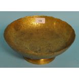 An Indonesian brass footed bowl, decorated peacocks,