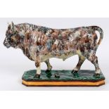 A Wedgwood cream ware bull, with mottled glaze decoration (horn and ear a.f.), 30 cm high  See