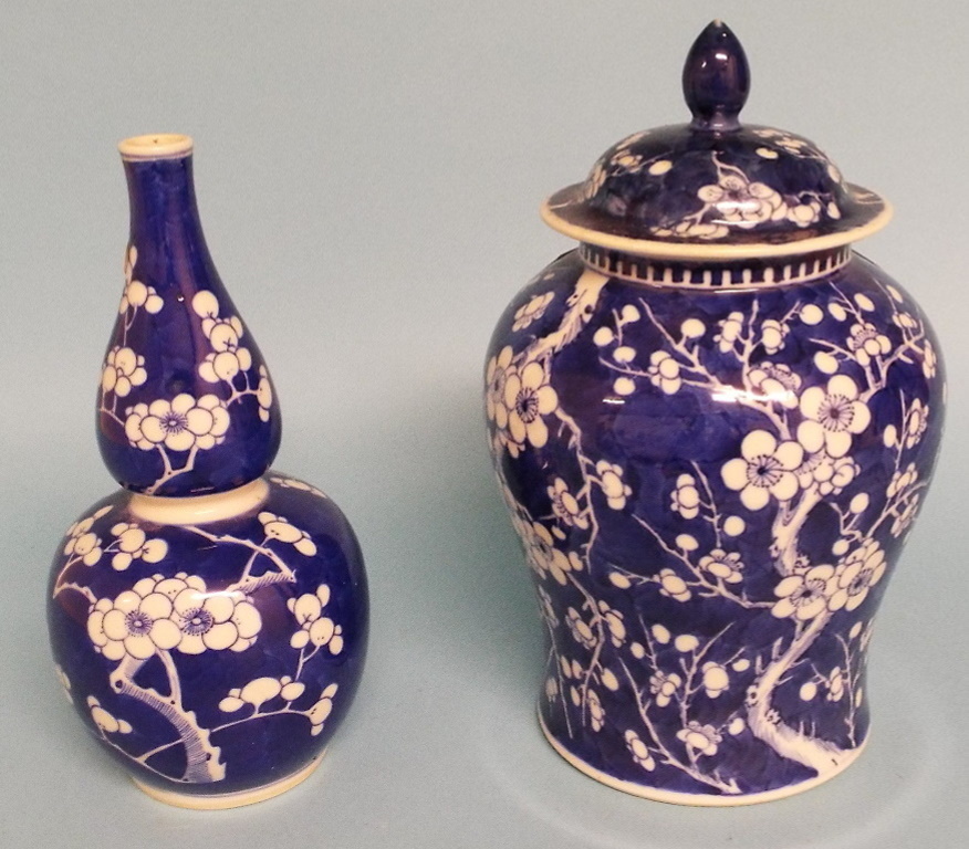 A Chinese porcelain vase and cover, decorated prunus in underglaze blue, 22 cm high, and a similar