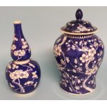 A Chinese porcelain vase and cover, decorated prunus in underglaze blue, 22 cm high, and a similar