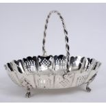 A late Victorian silver swing handled basket, with pierced decoration, on four leaf capped pad feet,