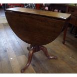 A mahogany drop leaf table, on tripod base,