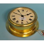 A ship's bulkhead clock, in a brass case, 20 cm diameter Condition report with key