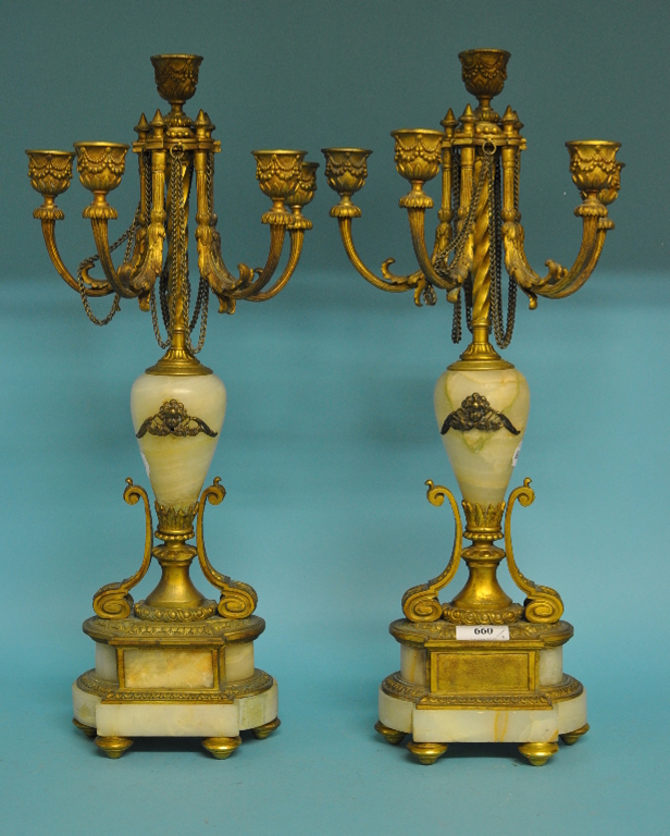A pair of gilt metal and alabaster candelabra,