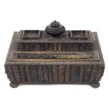 A Vizagapatam style carved horn desk stand, on bun feet, 32 cm wide  See illustration Condition