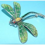 A silver coloured metal and enamel dragonfly brooch, with cabochon opal body and ruby eyes,