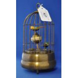 A novelty clock, in the form of birds in a cage,