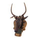 A 19th century carved and painted wood stag head, on a shield shaped plaque,