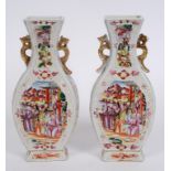 A pair of Chinese porcelain famille rose vases, decorated figures, 26.5 cm high (both a.f.) (2)  See
