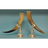 A pair of horns on plated metal stands,