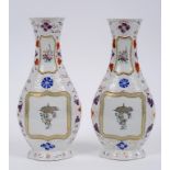 A pair of Chinese porcelain famille rose vases, (one cracked) 29.5 cm high (2)  See inside front