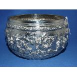 A Burmese style silver coloured metal bowl, embossed figures, 18 cm diameter Condition report Report