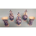 A Delft garniture, comprising three vases and covers, 23 cm high, and a pair of vases,