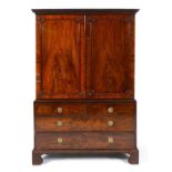 A mahogany wardrobe, the Greek key cornice above a pair of panel doors,