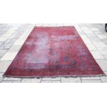 An Afghan carpet, decorated elephant ghuls, on a red ground,