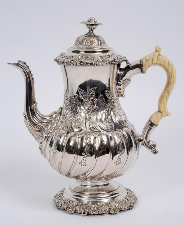 A 19th century silver plated coffee pot, with embossed decoration and an ivory handle,