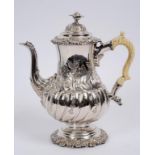 A 19th century silver plated coffee pot, with embossed decoration and an ivory handle,