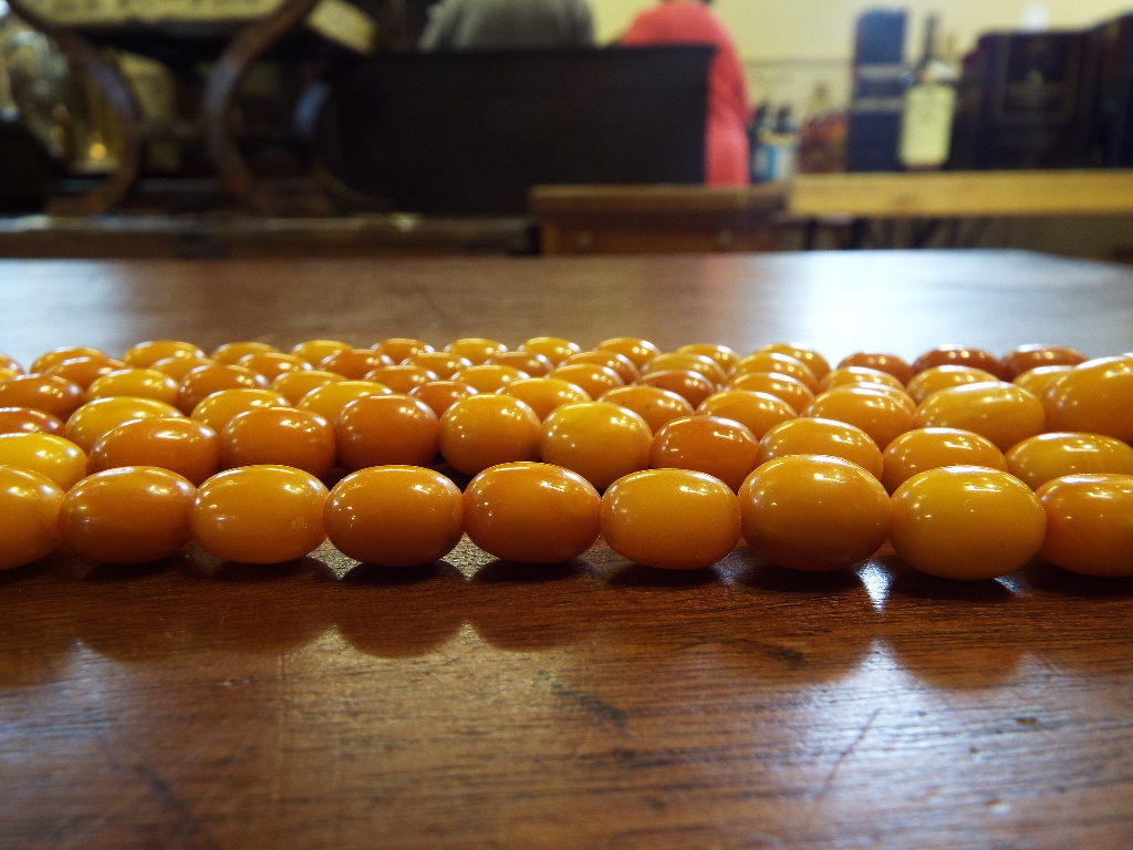 A string of amber style beads, with a te - Image 7 of 10