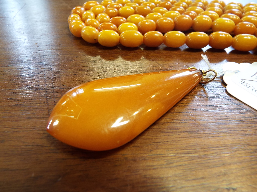 A string of amber style beads, with a te - Image 10 of 10