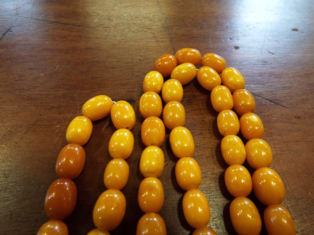 A string of amber style beads, with a te - Image 5 of 10