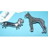 Two silver dog brooches