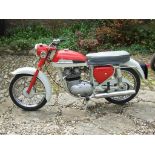 A 1963 Norton Jubilee, registration number UJT 499, red.